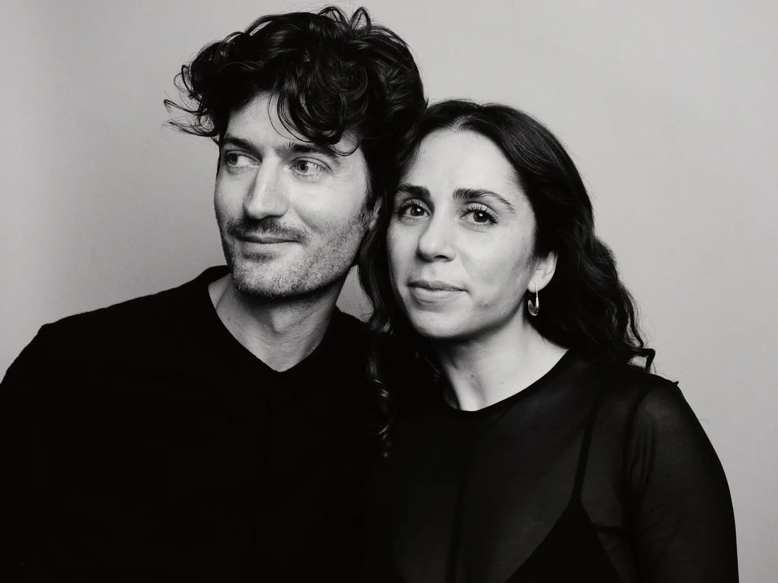 Calvin and Gabriella, Toronto headshot photographers and founders of Calvin Thomas Studio, photographed together in black and white against a soft grey background
